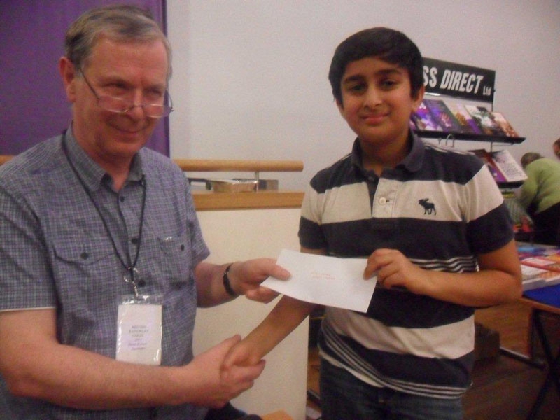 The Congress Secretary presents Karam Sangha with his prize